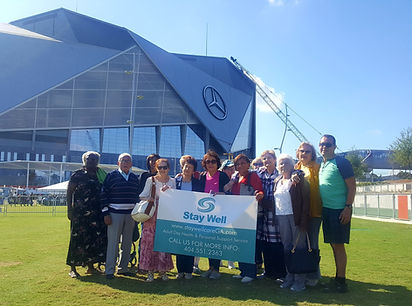 Group of people outdoors holding a banner