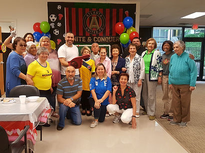 Residents and staff celebrating in a common area.