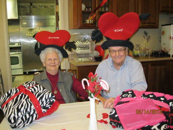Residents celebrating with festive hats and blankets.