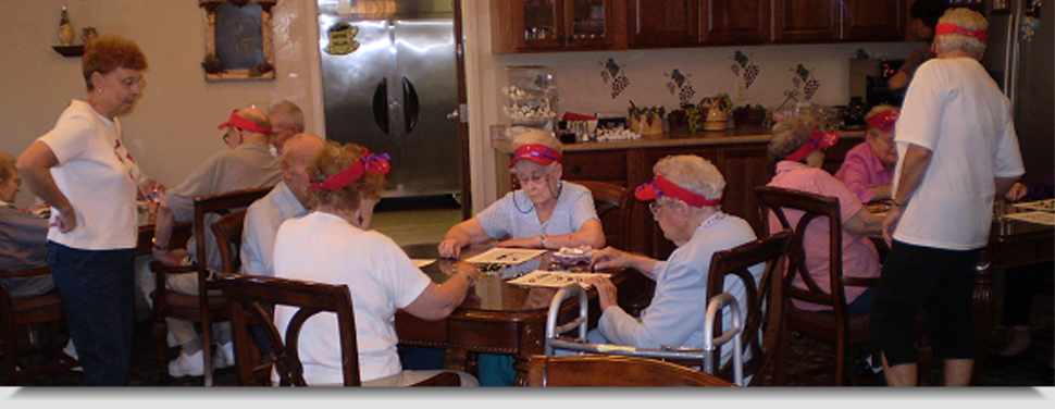 Residents engaged in a group activity with staff oversight.