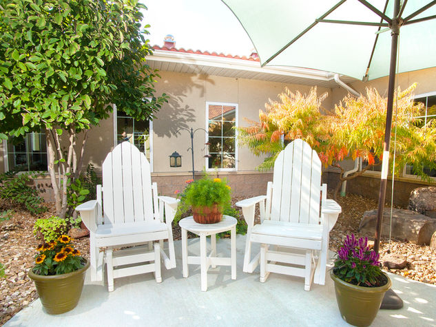 Outdoor seating area with plants and decor.