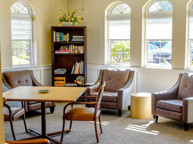 Cozy reading nook with comfortable chairs and bookshelves.