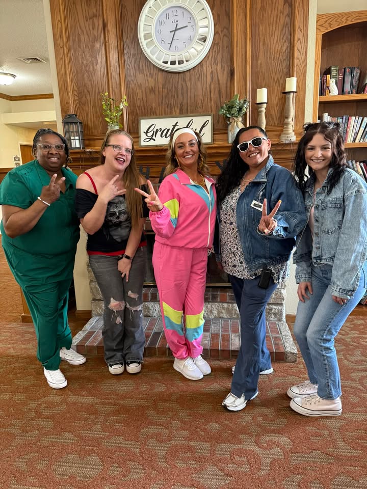 Staff and residents posing together in a common area