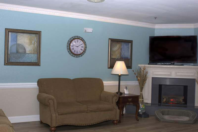 Cozy common area with a sofa and clock.