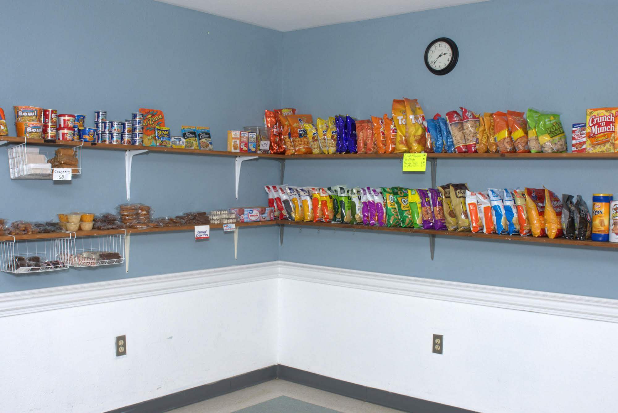 Snack shelf with various food items displayed.