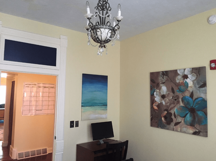 Decorative interior space with paintings and a computer