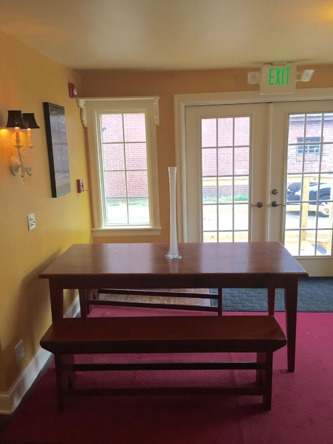 Interior seating area with a table and windows.