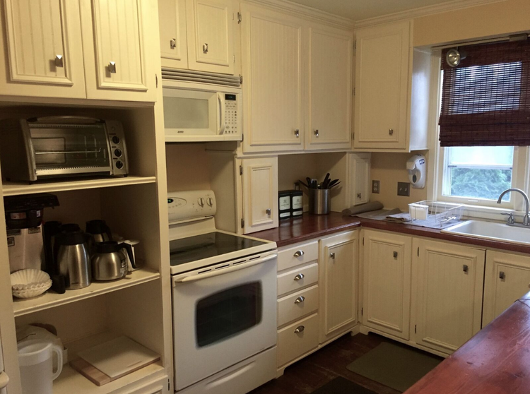 Bright kitchen area with appliances and cabinets