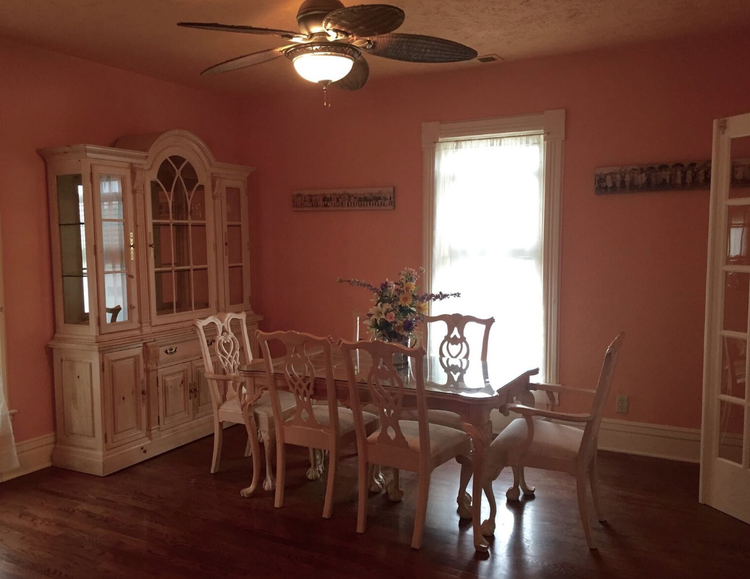 Brightly lit common area with a dining table.