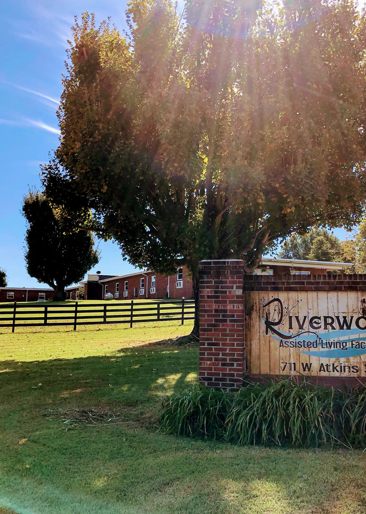 Exterior view of Riverwood Assisted Living Facility sign.