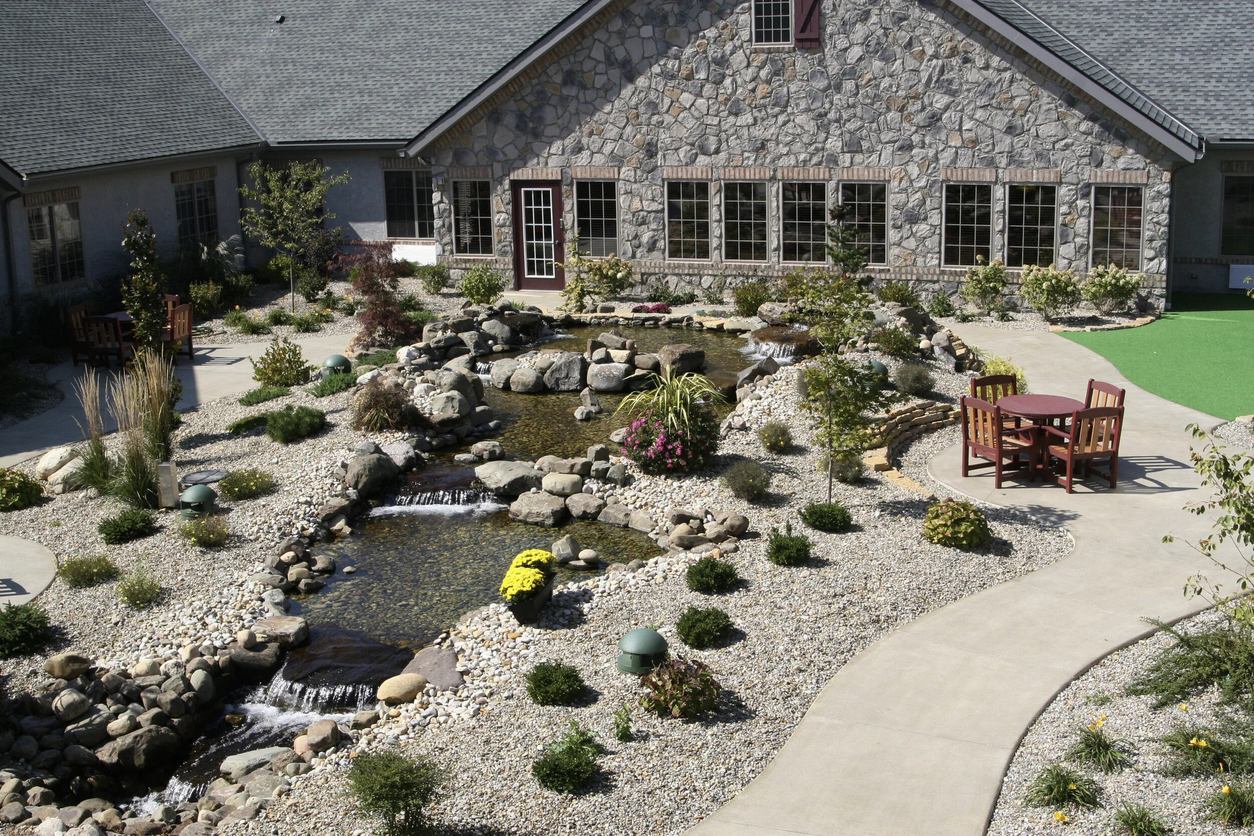 Beautifully landscaped outdoor area with water feature.