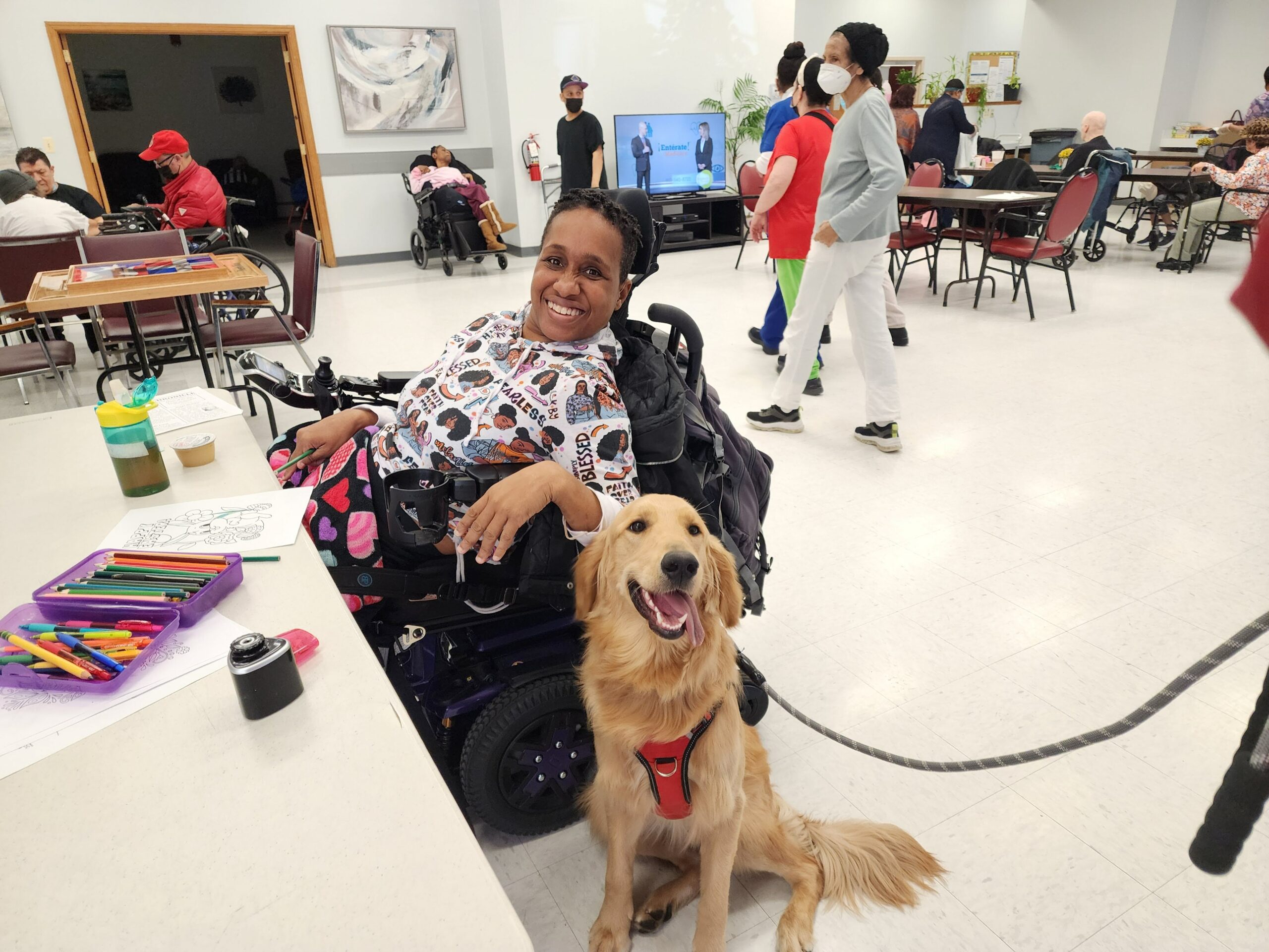 Resident smiling with therapy dog during an activity