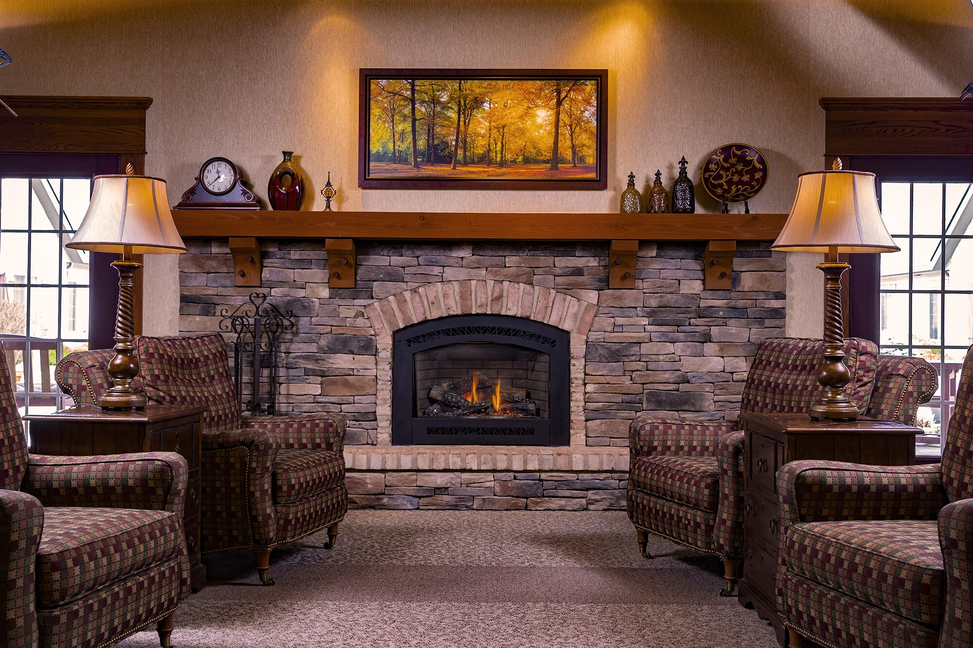 Cozy common area with armchairs and fireplace.