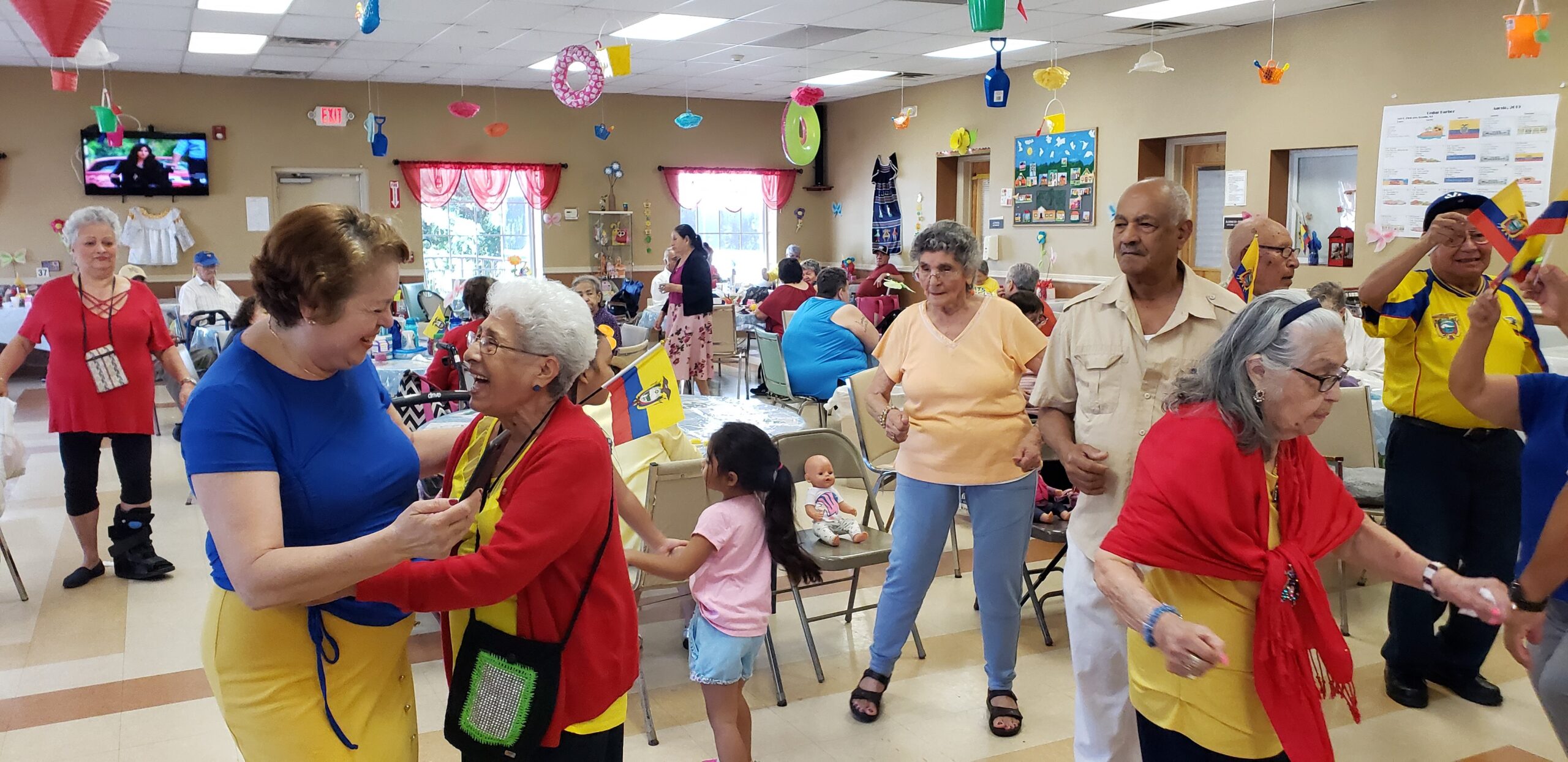 Seniors enjoying a lively dance event indoors.