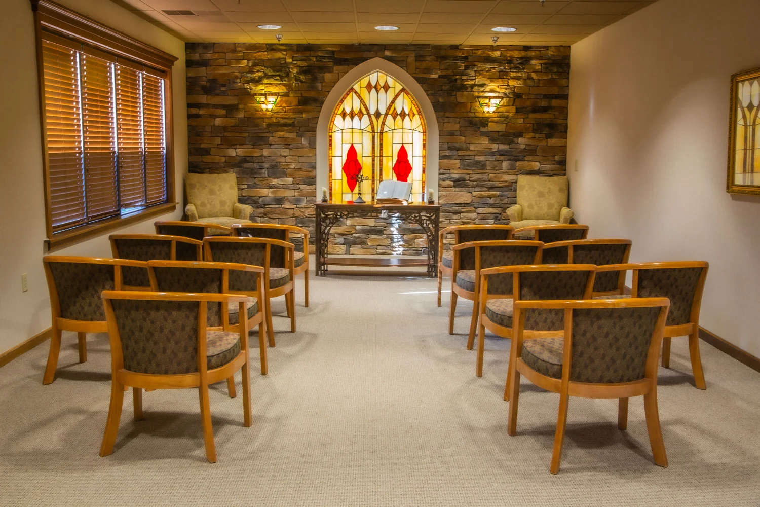 Cozy communal space with chairs and stained glass