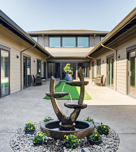 Courtyard with a fountain and flowers.