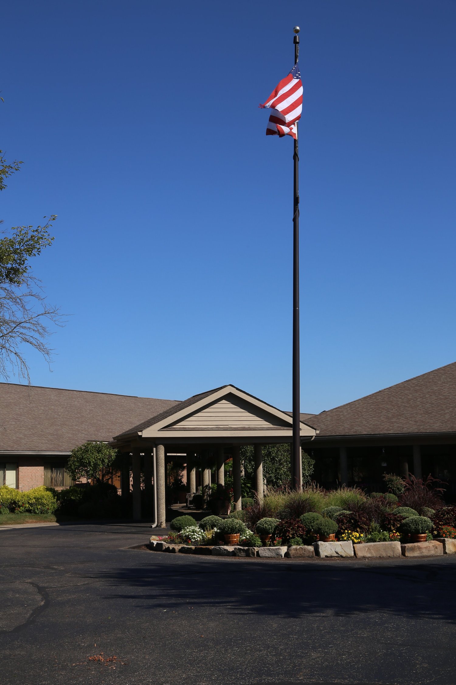 Entrance of assisted living facility with flag