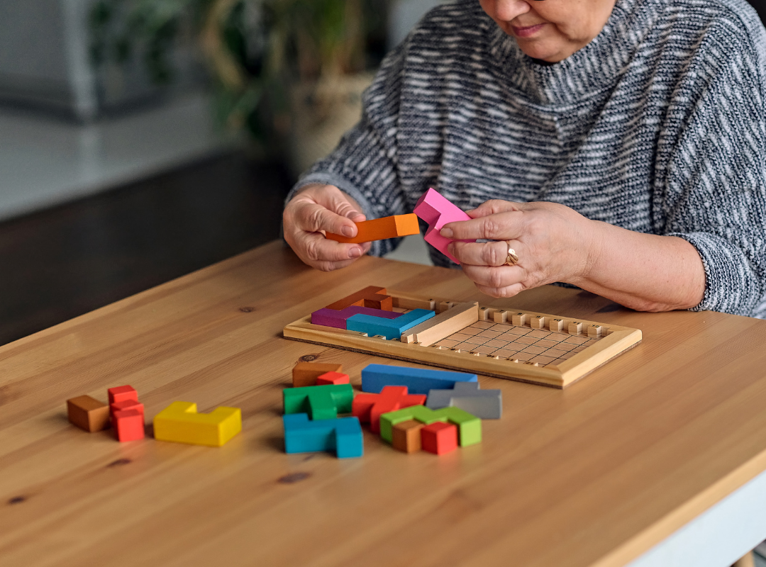 Senior woman engaging in a colorful puzzle activity