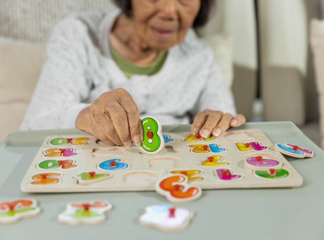 Senior woman engaging with a colorful puzzle.