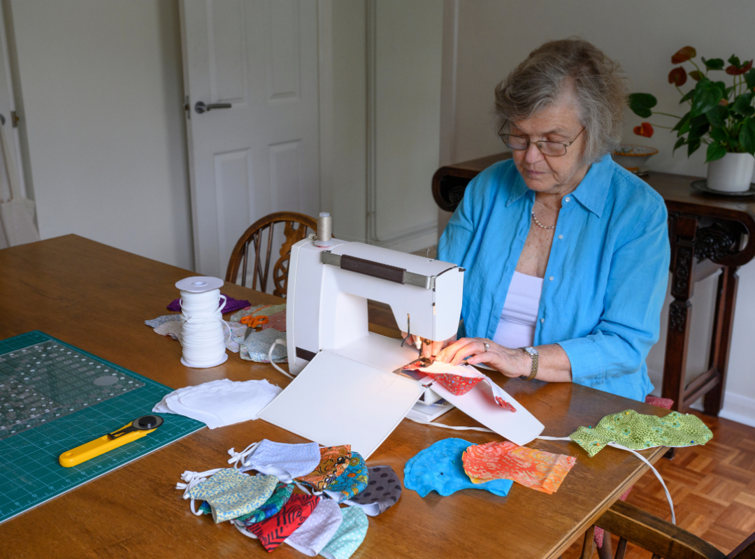 Senior woman sewing at a table