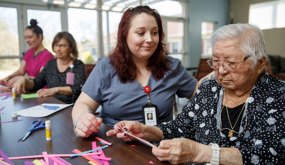 Residents and staff engaged in a craft activity