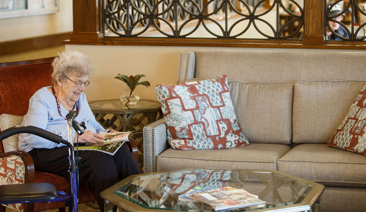 Resident enjoying a magazine in the common area