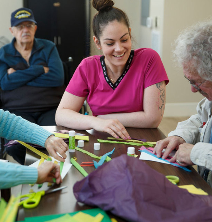 Residents and staff engaged in a craft activity.