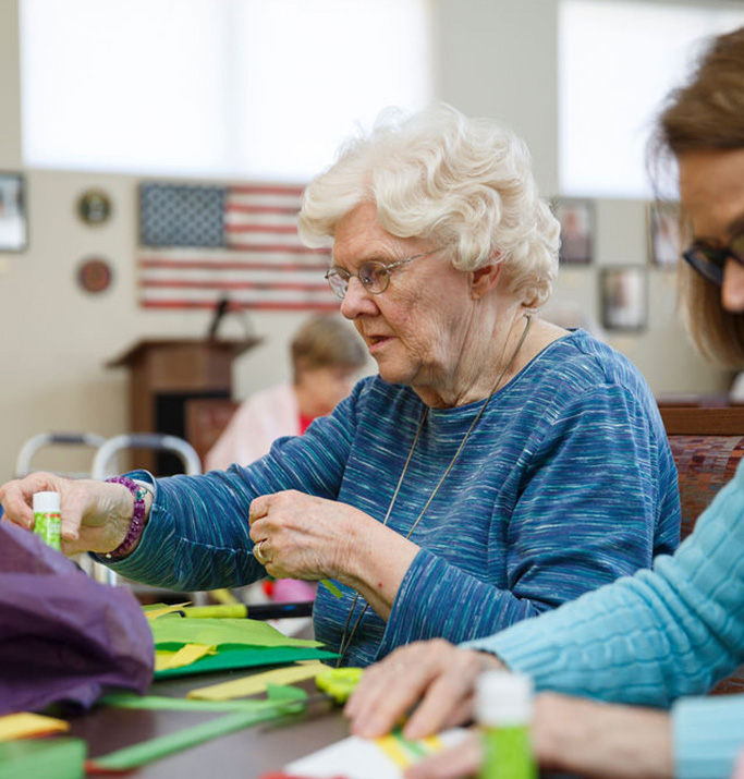 Senior residents participating in an arts and crafts activity.