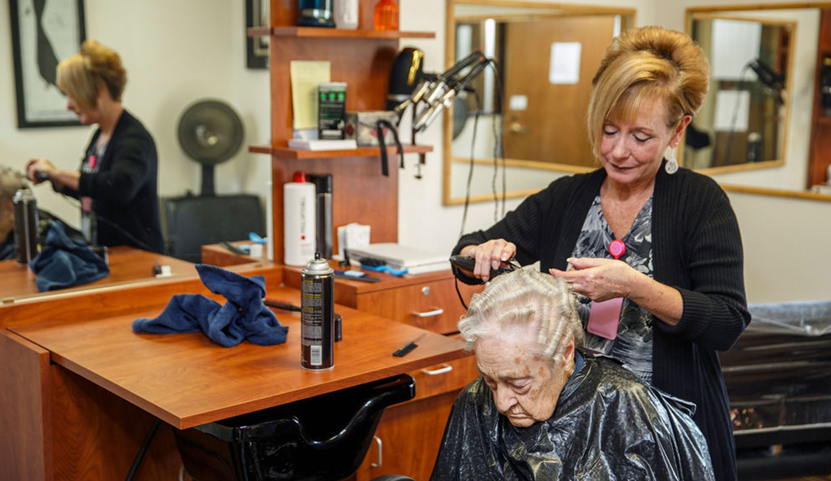 Resident receiving a haircut in the salon