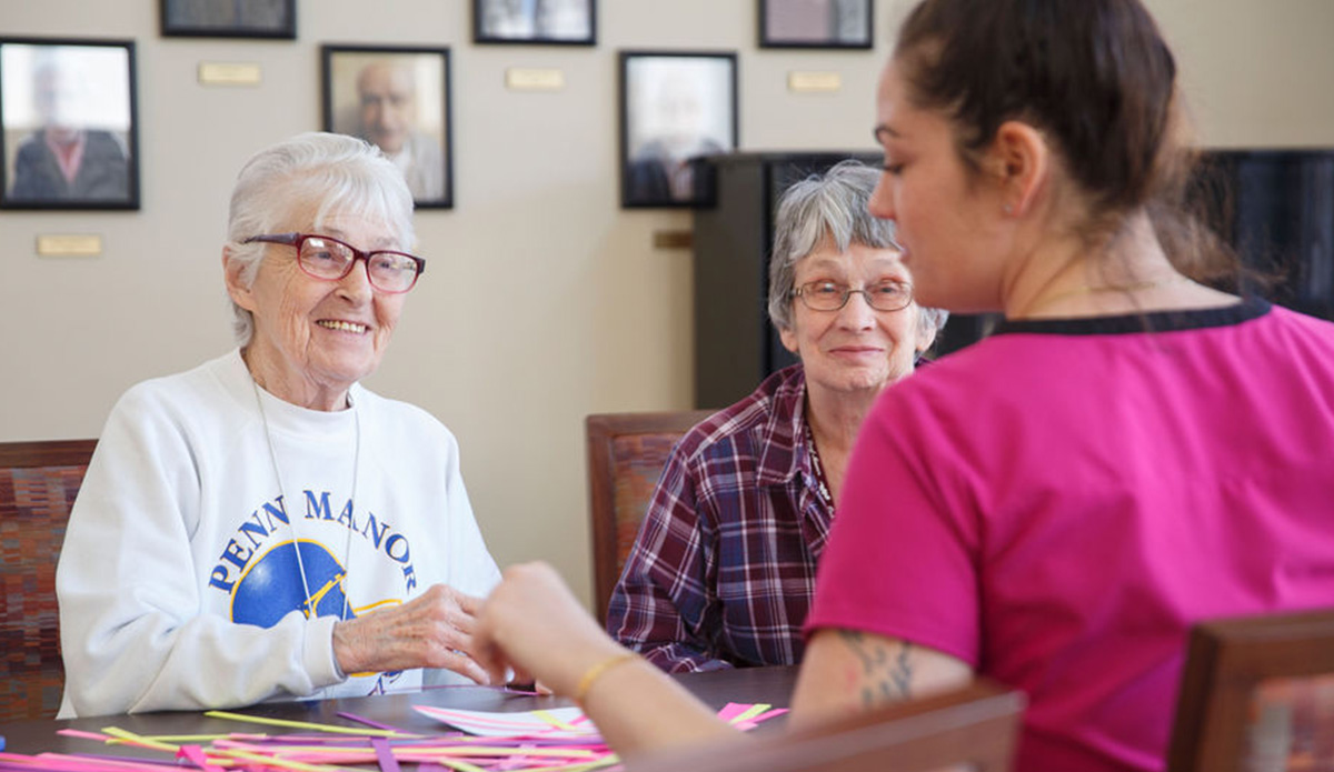 Engaged residents enjoying an activity with staff.