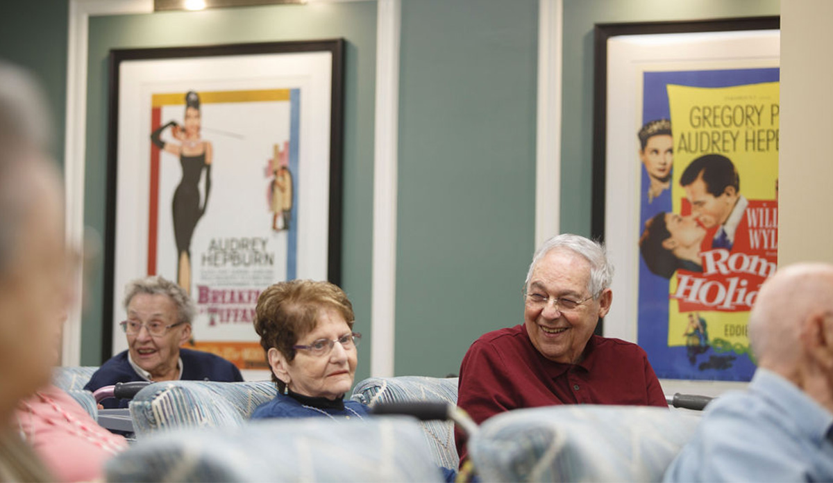 Residents enjoying a common area with movie posters.