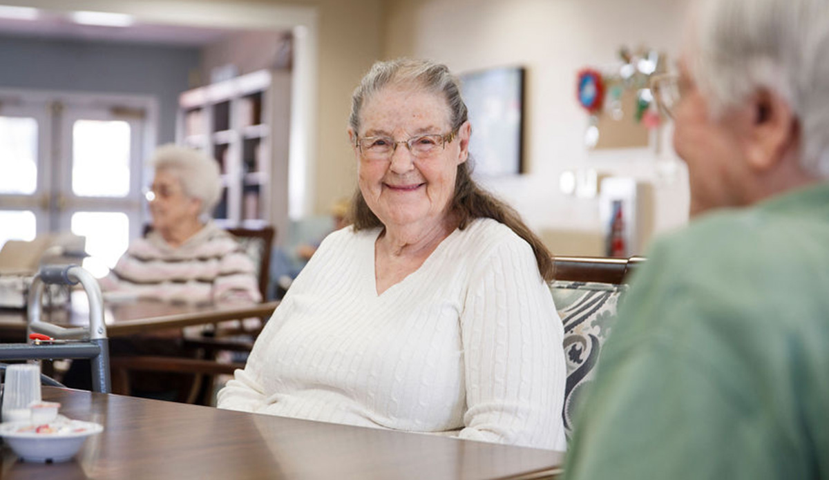Smiling elderly resident enjoying conversation