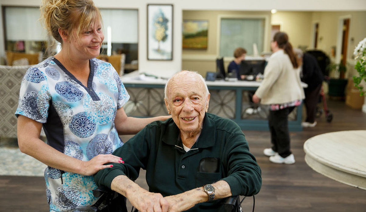 Staff and resident interacting in a common area.