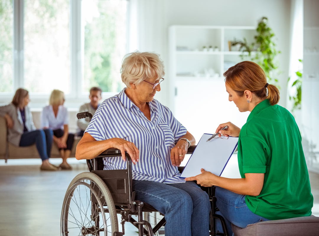 A caregiver assists a resident in a common area.