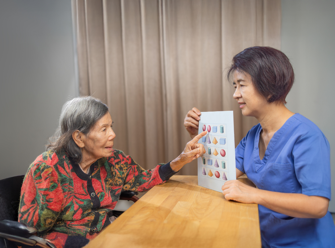 Staff engaging with a resident in a therapeutic activity.