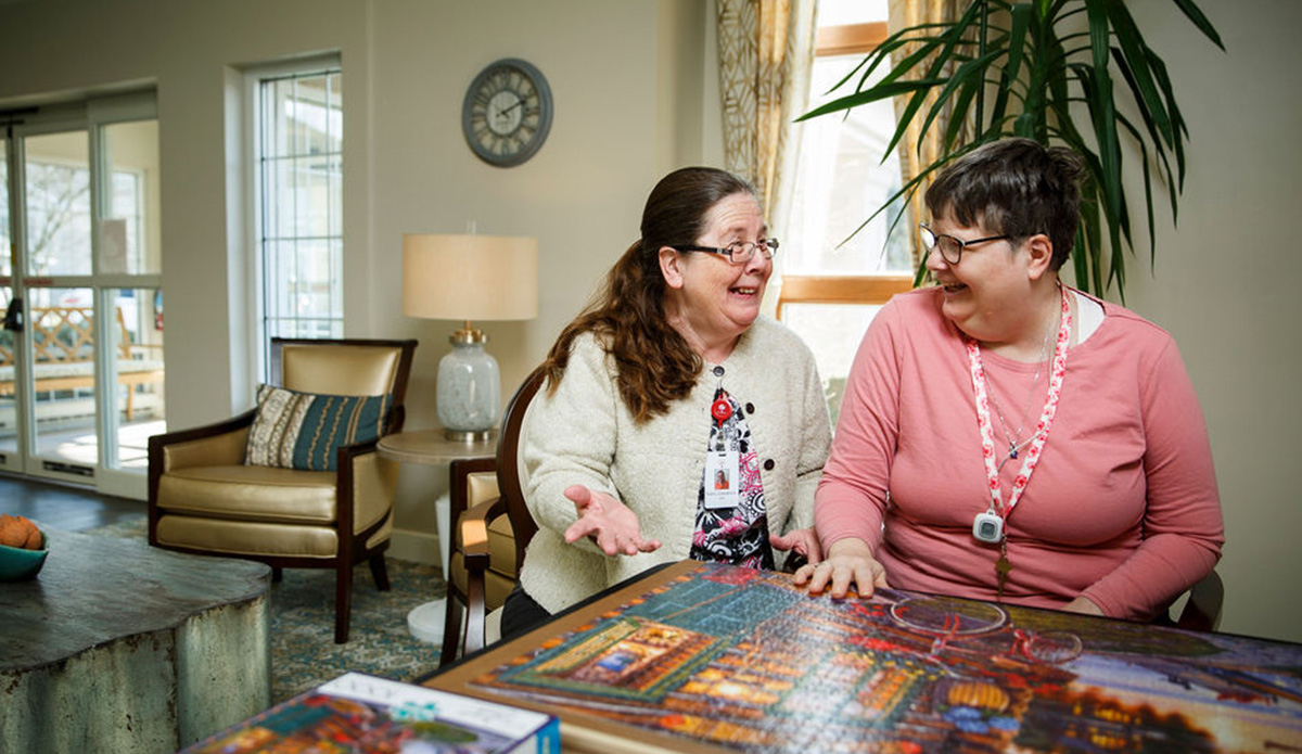 Two women sharing a moment in a common area.