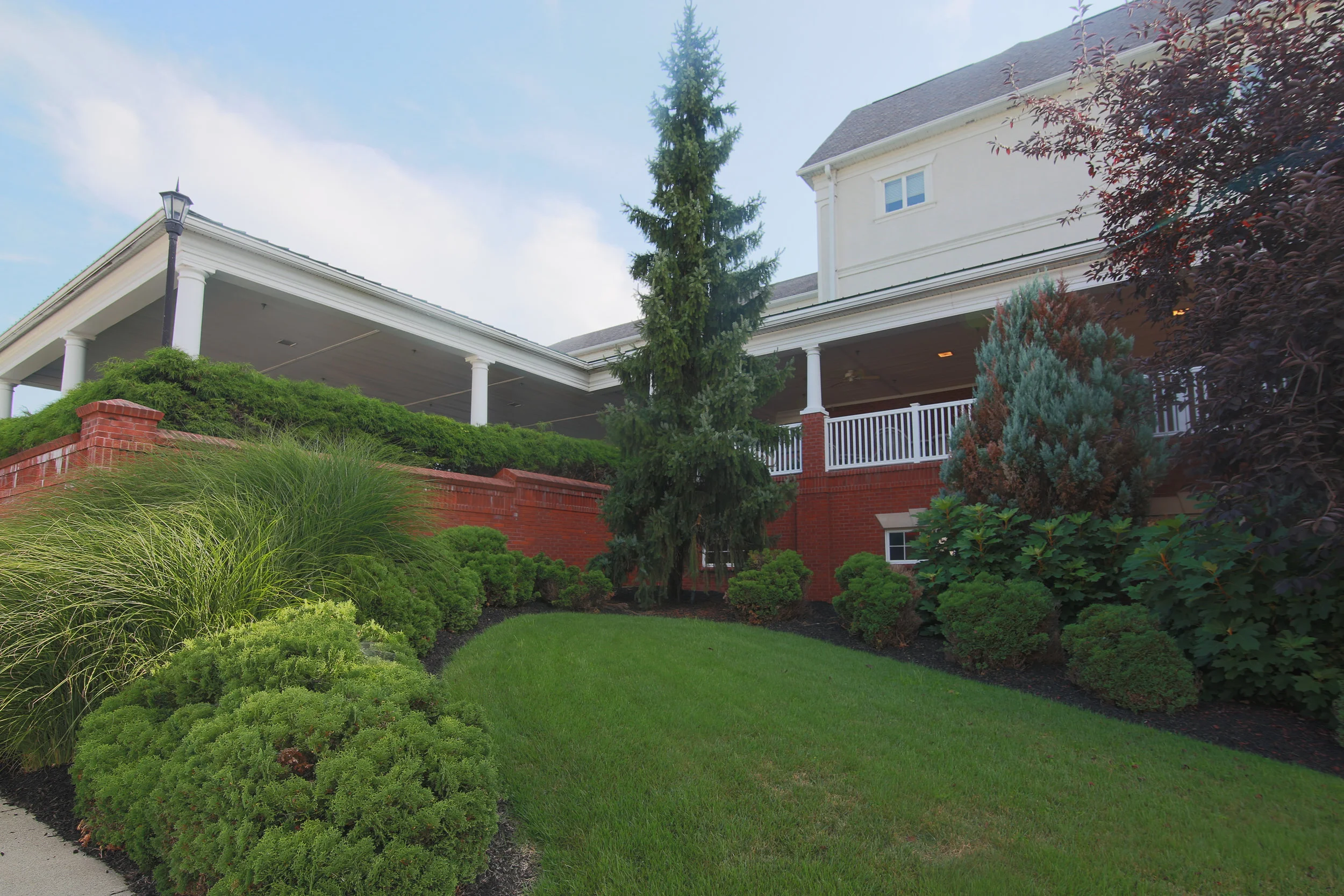 Exterior view of landscaped area with building in background.