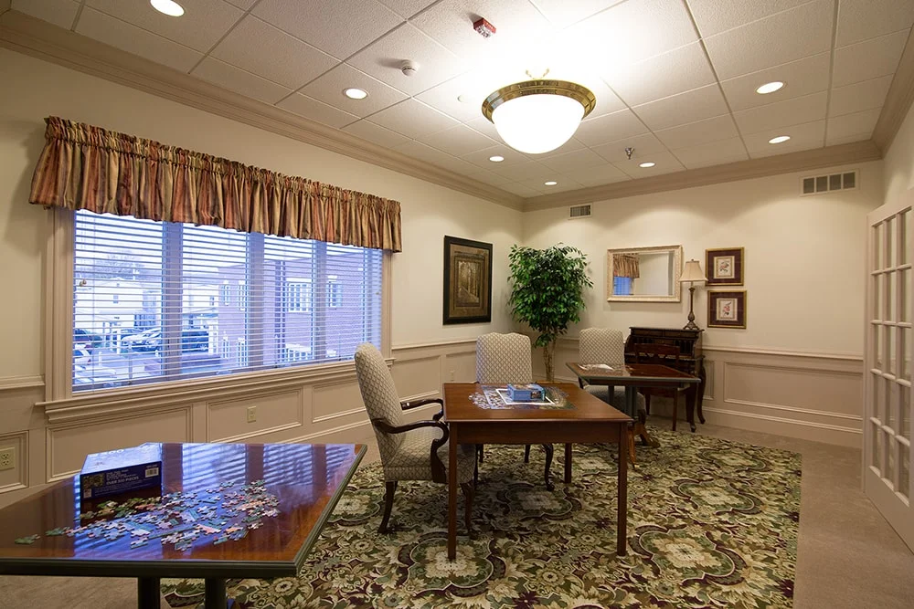 Cozy common area with seating and a puzzle table.