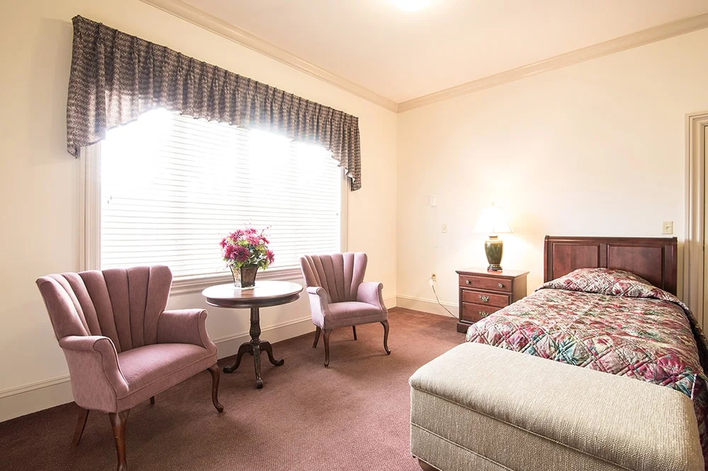 Cozy resident room with furniture and decor.