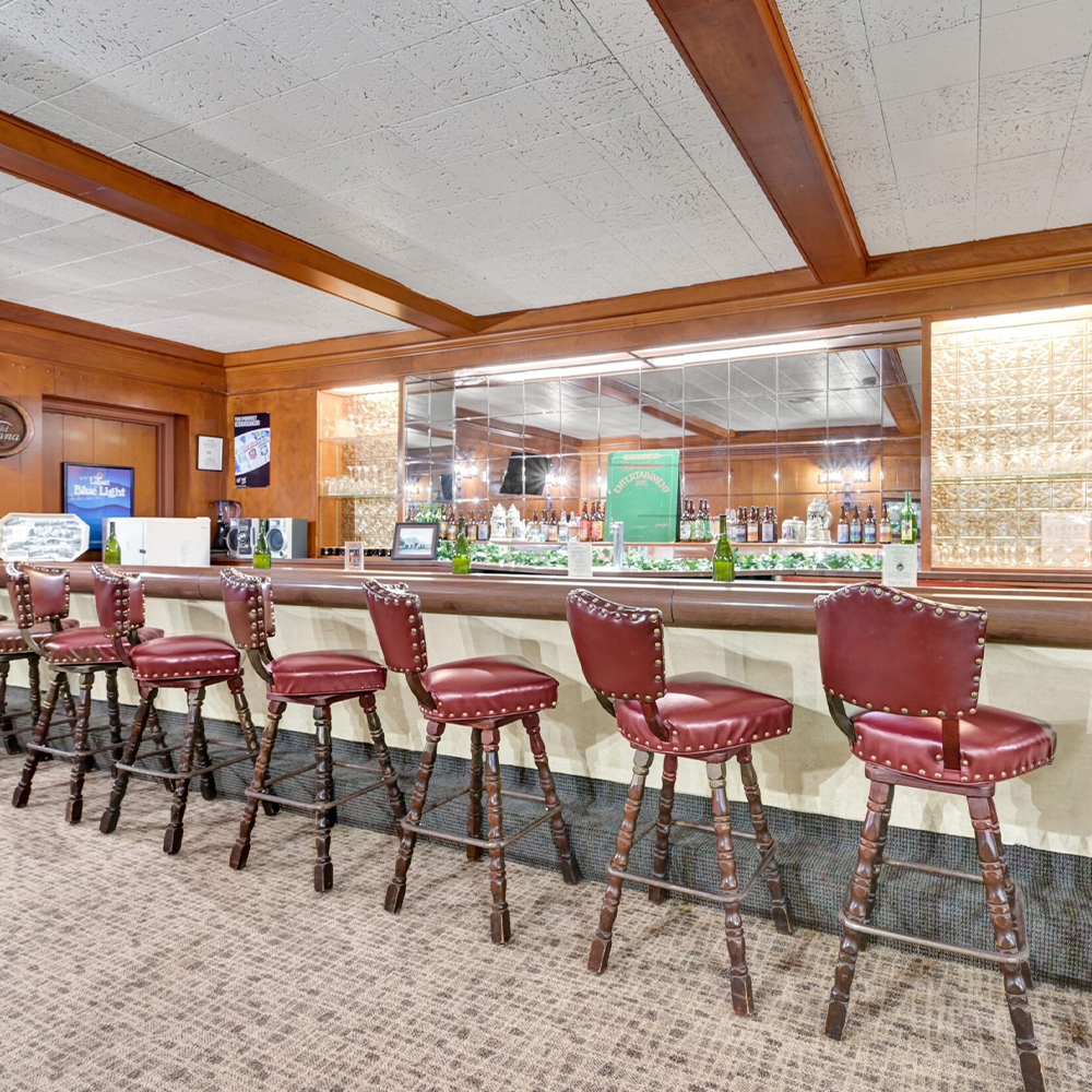 An interior bar area with high stools