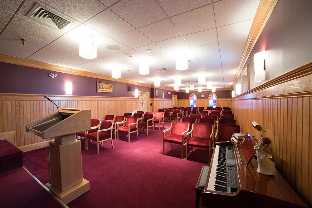 Interior of a multi-purpose room with chairs and a podium.