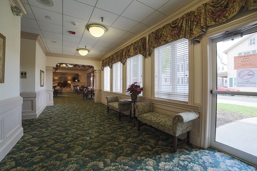 Interior common area with seating and decorative windows.