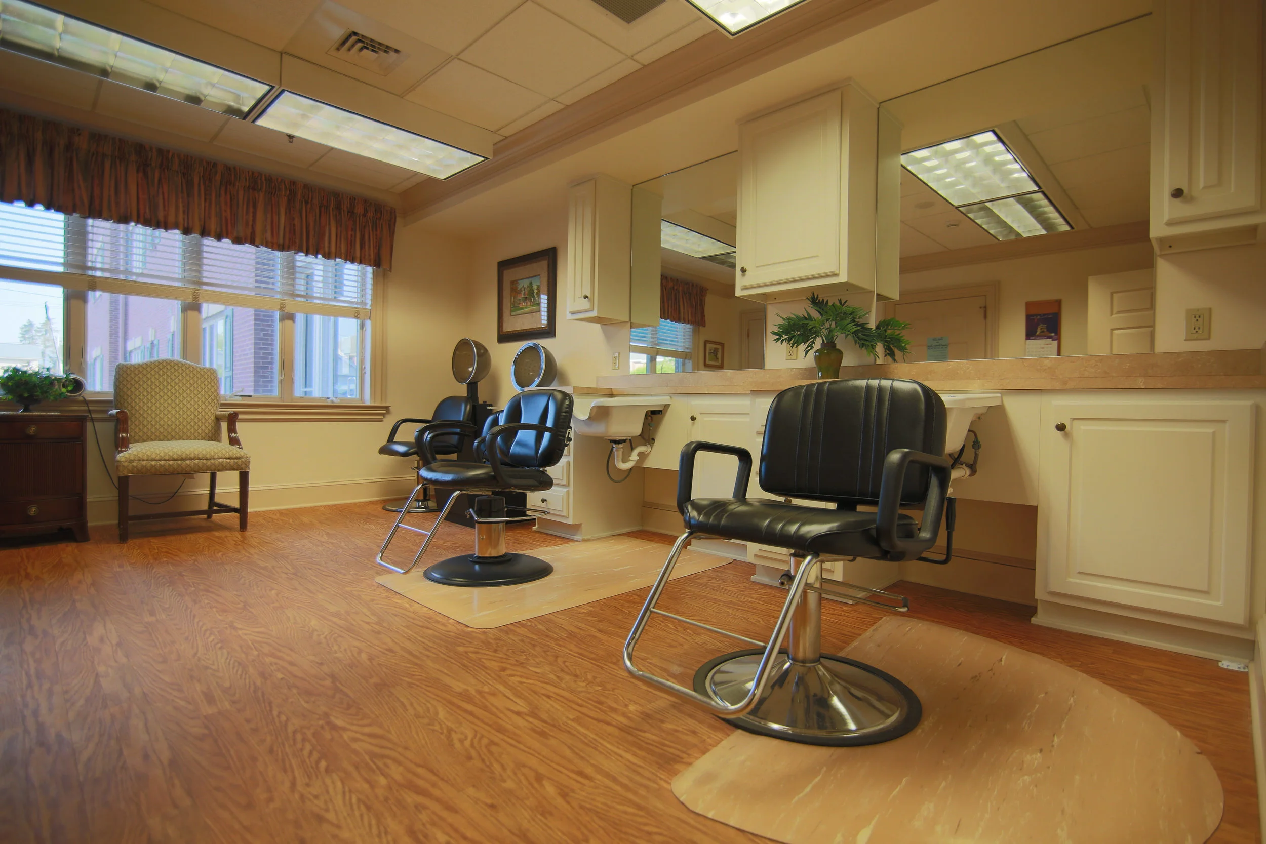 Hair salon area with styling chairs and mirrors