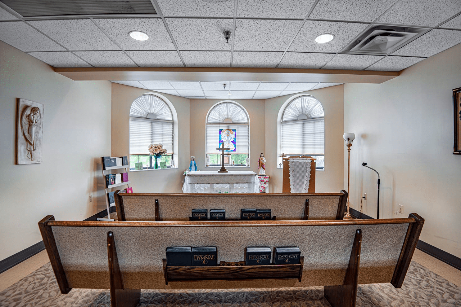 Serene chapel interior with seating and stained glass