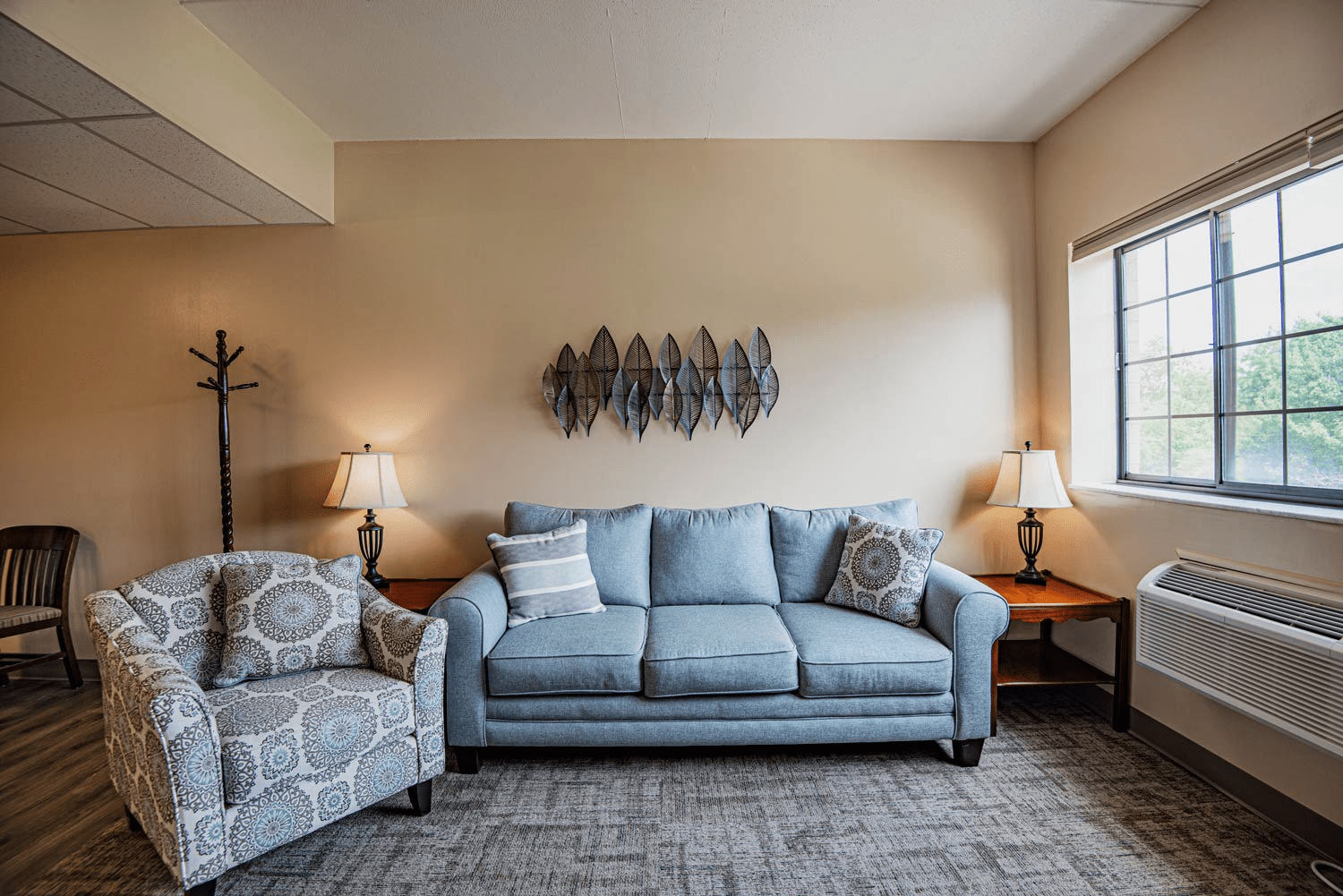 Comfortable living area with blue sofa and chairs