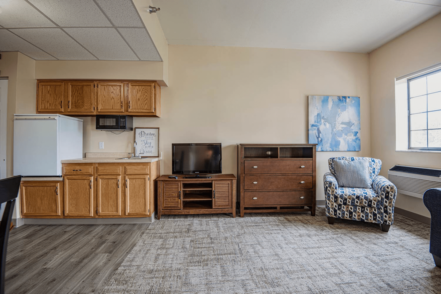 A cozy apartment living area with kitchenette.