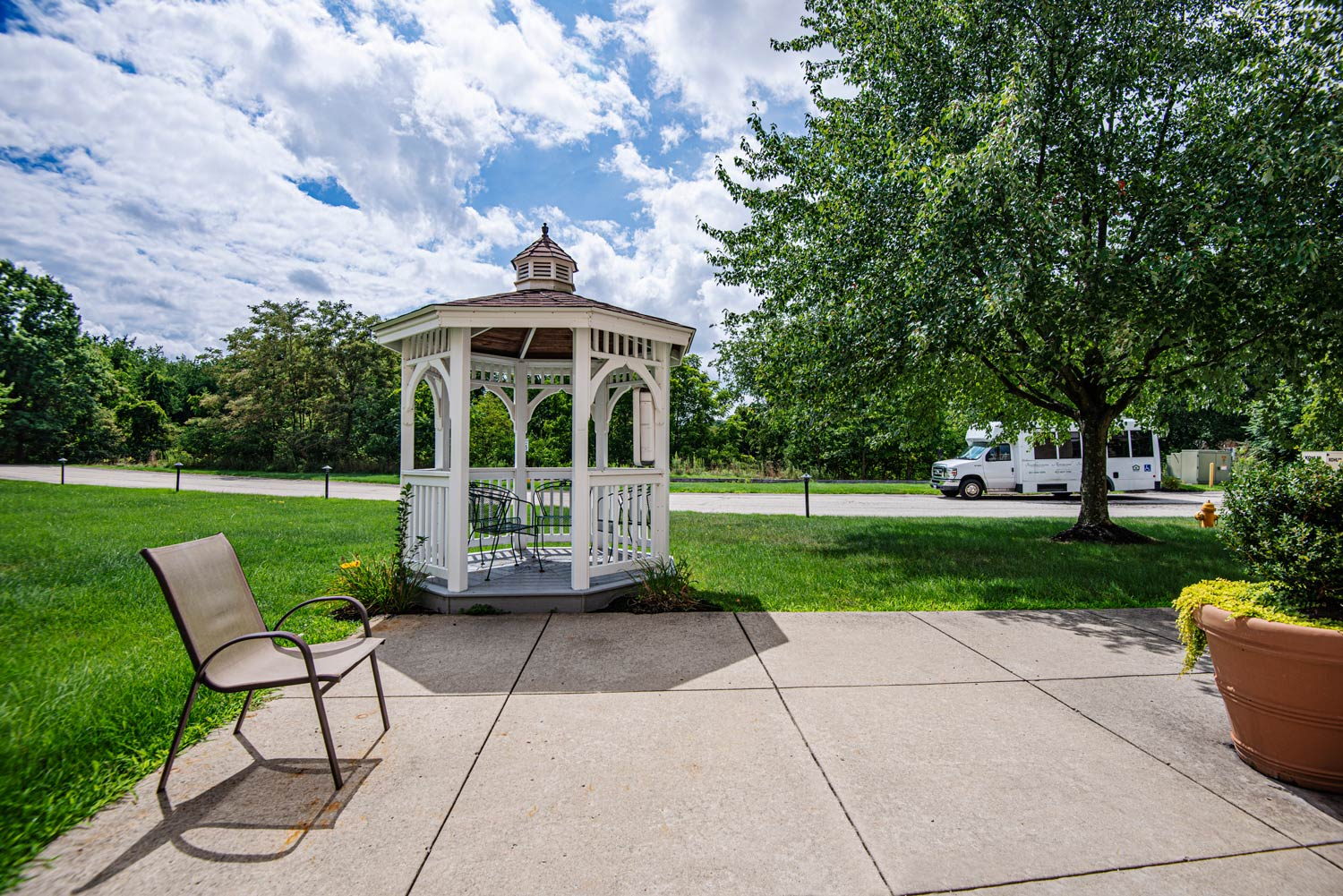 Outdoor gazebo with seating and landscaping