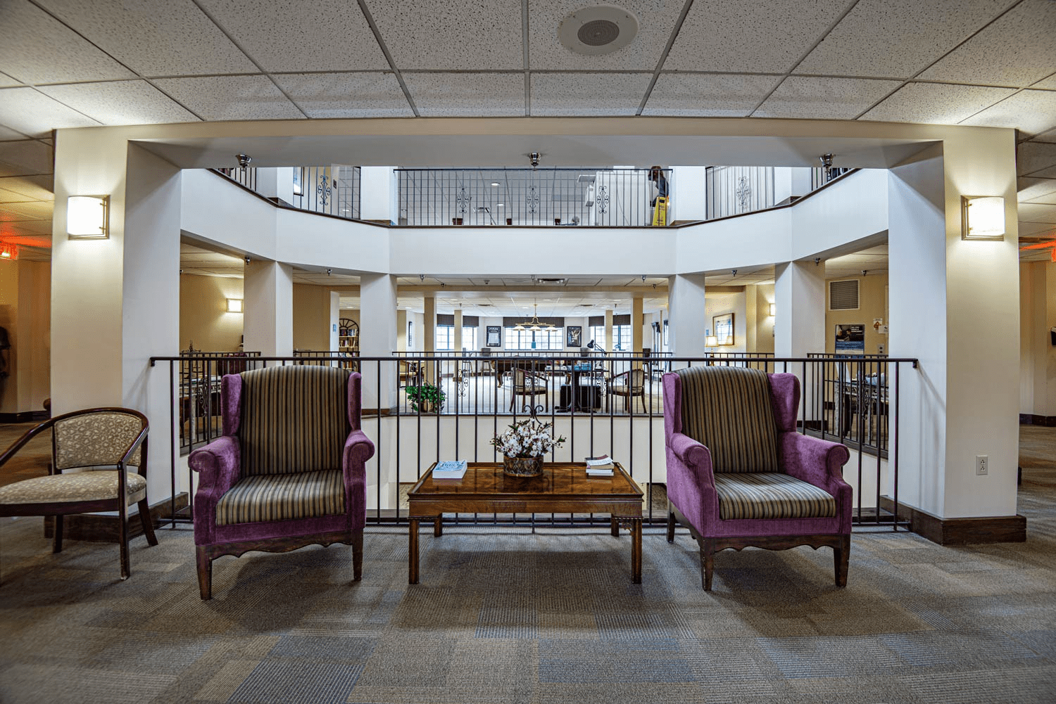 Common area with chairs and decor in a nursing home.