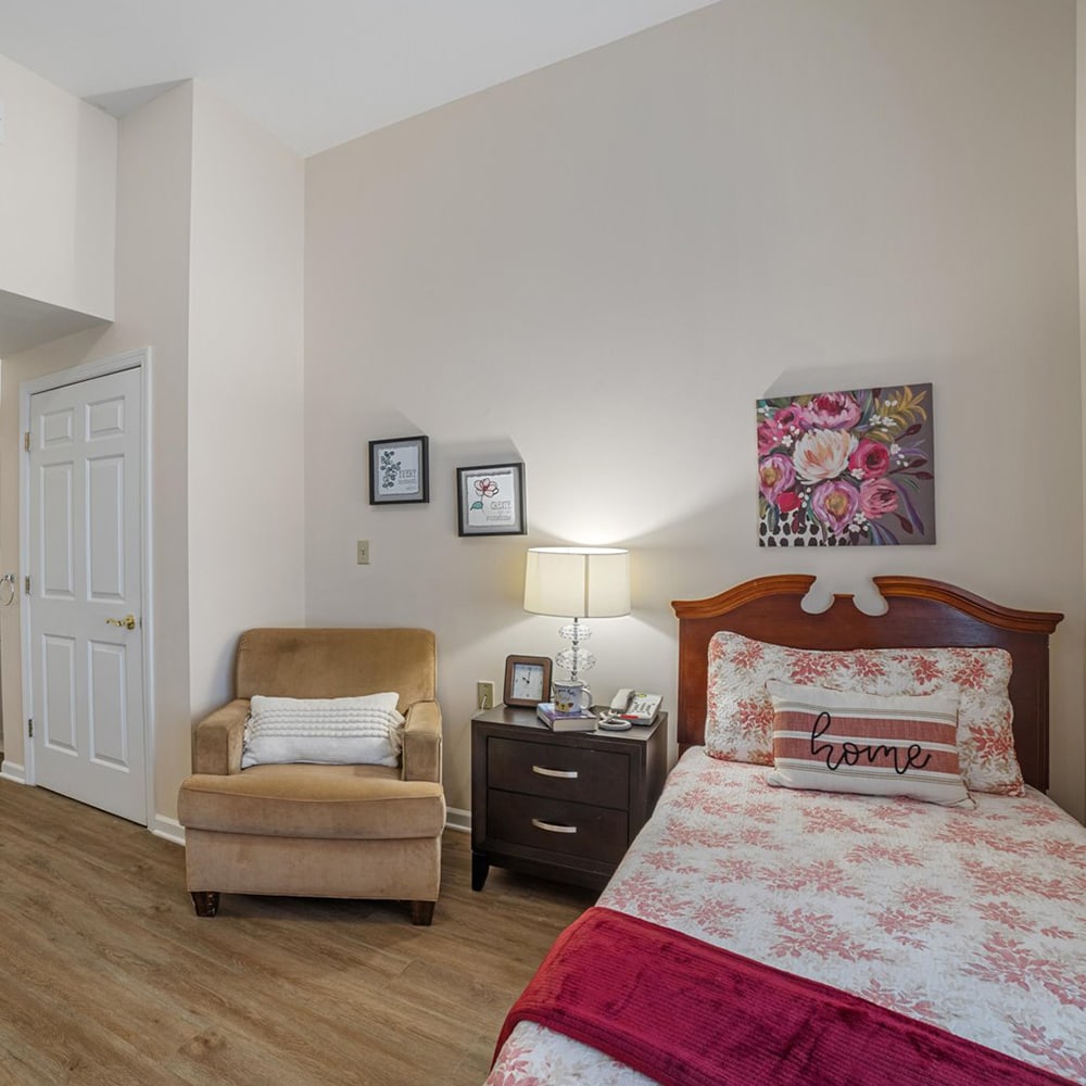 Cozy resident room with a bed and armchair