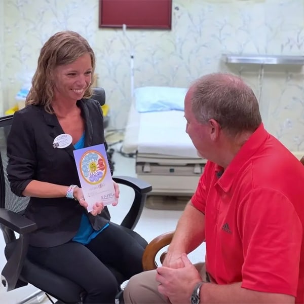 Staff member engaging with a resident in a care room